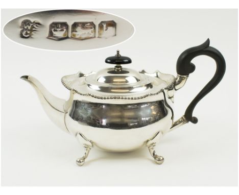 SILVER TEAPOT, early 20th century of oval form with four feet, ebonised handle Sheffield 1927, makers Walter and Charles Siss