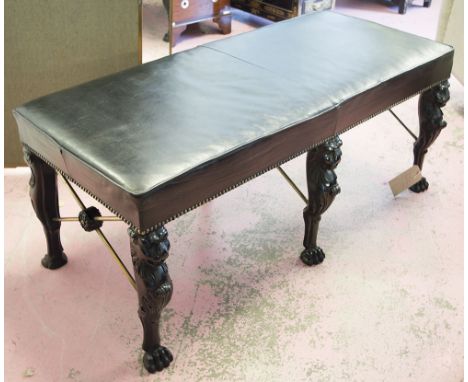 HALL BENCH, Regency style black leather and ebonised in the manner of Thomas Hope with six lion monopodia and brass 'x' stret
