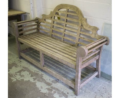 LUTYENS STYLE GARDEN BENCH, weathered teak slatted construction with scroll arms, 172cm W.