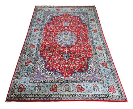 EXTREMELY FINE ISPHAHAN RUG, 244cm x 149cm, pendant medallion on a ruby field of palmettes and scrolling vines within complim
