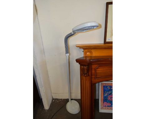 AN ADJUSTABLE FLOOR STANDING CRAFT LAMP