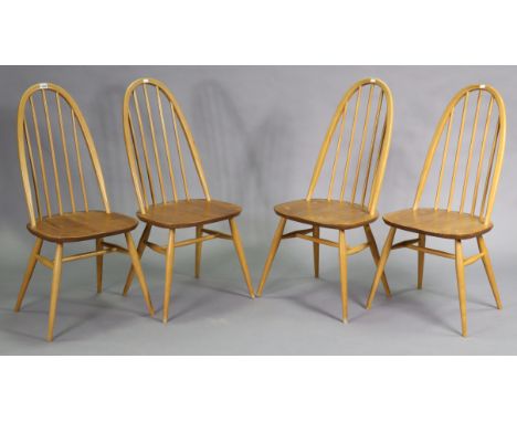 A set of four Ercol light elm dining chairs each with spindles to the hooped back, with hard seat, &amp; on four round tapere