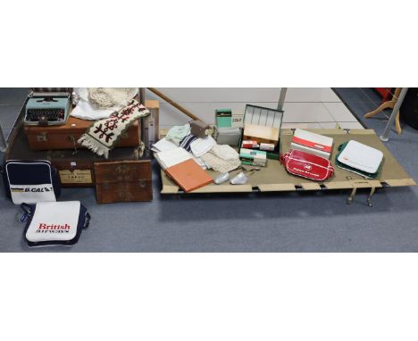 A foldaway camp bed, a fibre-covered travelling trunk and suitcase, three various airway holdalls, various items of household