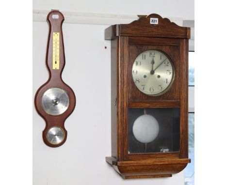 A mid-20th century wall clock with a striking movement, and in an oak case, 25” high, together with a small wall barometer an