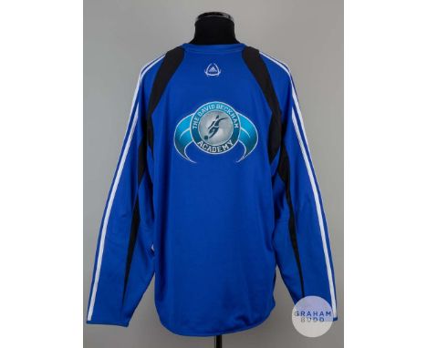 A blue David Beckham Academy long sleeved sweatshirt , Adidas size 46/48 crew neck collar with printed badges on the front an