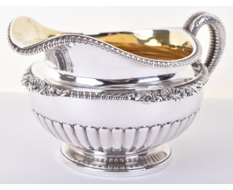 A fine George III silver cream jug, by Paul Storr, London 1816, gadrooned rim, serpent handle, the body decorated with shell 