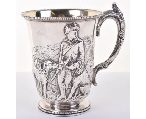 A Victorian silver cup, by John &amp; Edward Barnard, 1858 decorated in high relief of a hunting scene of boy and hounds, 10c