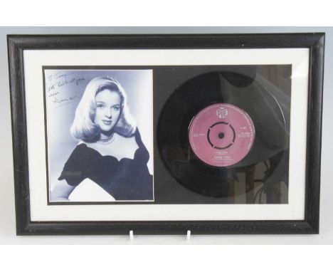 Diana Dors, an 18 x 14cm black and white photograph with facsimilie signature, together with April Heat 7" single mounted and