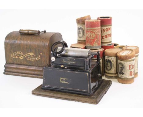 A late 19th century oak cased Edison Gem phonograph, serial no. G92735, case width 24cm, together with a collection of 12 wax