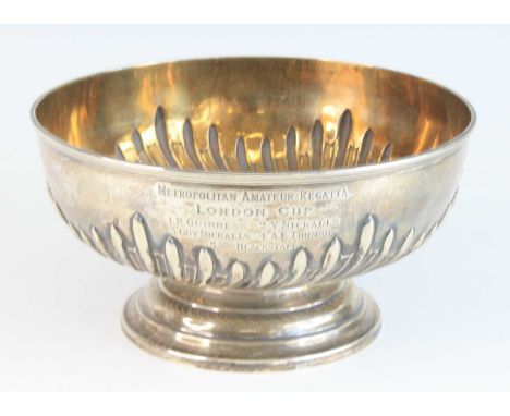 A late Victorian silver trophy bowl, of half-gadrooned circular form, bearing inscription 'METROPOLITAN AMATEUR REGATTA LONDO