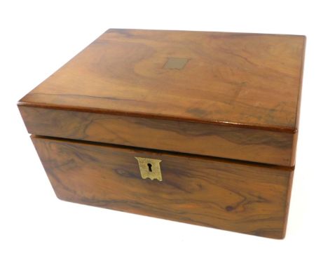 A Victorian olivewood writing box, with vacant cartouche, the hinged lid enclosing a velvet lined interior with inkwell, etc.