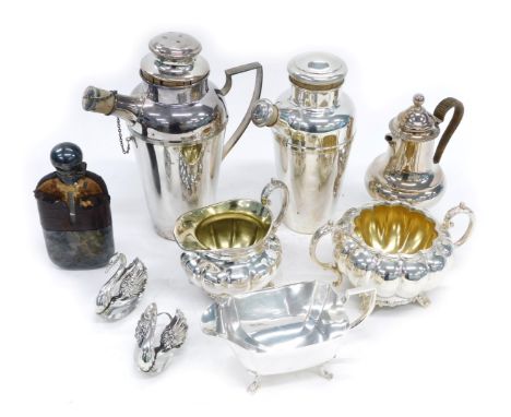 A group of silver plated wares, comprising two cocktail shakers, coffee pot, hip flask, milk jug, sugar bowl, swan preserve p