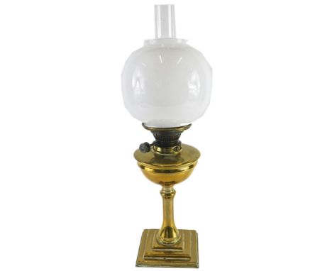 A late Victorian brass oil lamp, with opaque glass shade and chimney, the base 35cm high. 