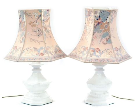 A pair of white ceramic table lamps, each with brass fittings, and an Oriental style shade, the lamps 40cm high. 