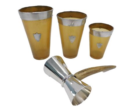 Three horn beaker, each with a silver rim and shield, together with a horn handled and stainless steel shot flask.  (4)