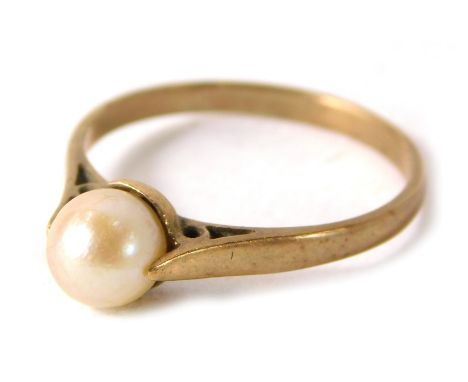 A cultured pearl dress ring, the single pearl in tension setting on a yellow metal band, stamped 9ct, ring size N, 1.7g all i