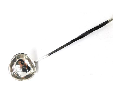 A Georgian style toddy ladle, with twisted ebony handle, on a shaped bowl, hallmarks rubbed, 16cm long. 