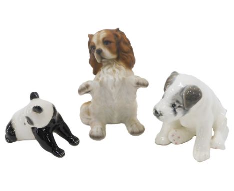 Three ceramic animals, comprising a USSR panda, a HHH Cavalier king Charles 13cm high, and a USSR seated puppy, 11cm high. (3