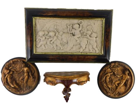 A Continental resin plaque, decorated with putti and a lion, a pair of similar plaques and a small Venetian wall bracket. (4)