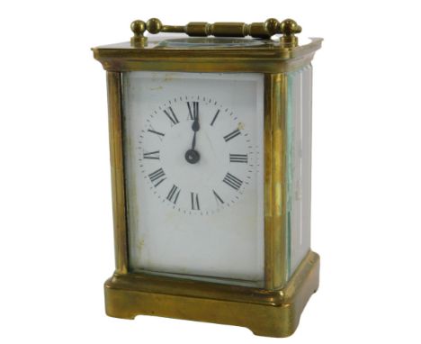 A French brass carriage timepiece, the white enamel dial with Roman numerals, 15cm high. 