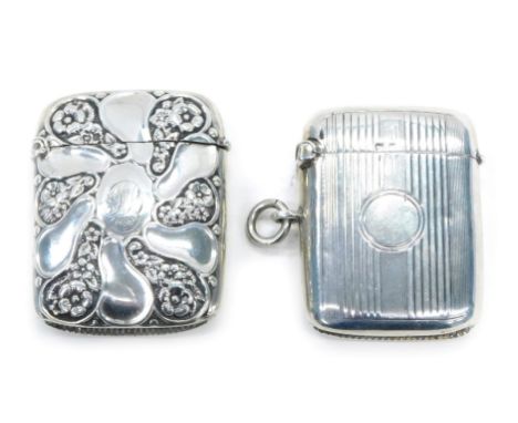 A Victorian silver Vesta case, with floral embossed decoration and another engine engraved, 1.7oz. (2)