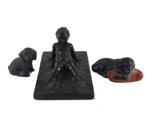 A Poole pottery model of a puppy with a slipper, a composition bronzed figure The Sea Urchin after E Halse dated 1919, and a 