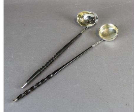 An 18th Century white metal punch ladle with circular bowl and twisted whalebone handle and an Elizabeth II Silver Jubilee pu
