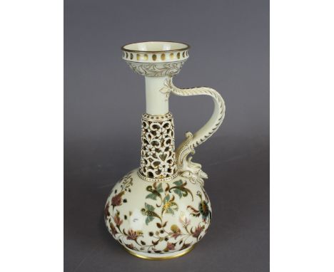 A Zsolnay Pecs porcelain reticulated oil lamp of Islamic form, decorated in colours and gilt with scrolled foliage, 20cm high