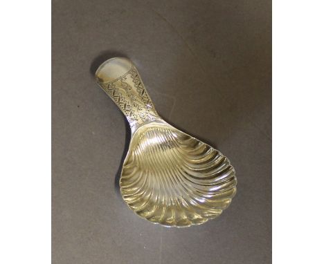 A George III silver caddy spoon by J.T., with scalloped bowl and bright cut engraved terminal, 6.7cm long, weight 7grams Birm