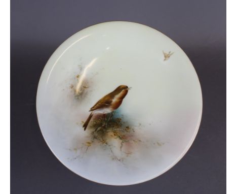 A Royal Worcester porcelain tall comport, decorated with a Robin by Ernest Barker, 24cm diameter x 11.5cm high, signed, purpl