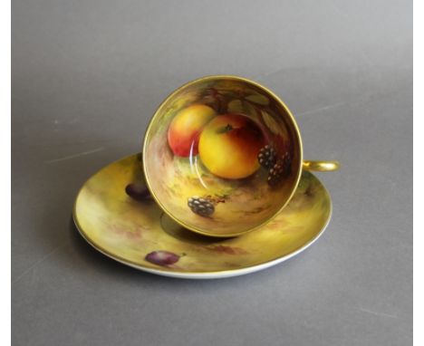 A Royal Worcester porcelain tea cup and saucer, decorated with fruit by Harry Ayrton, both signed, purple printed marks and d
