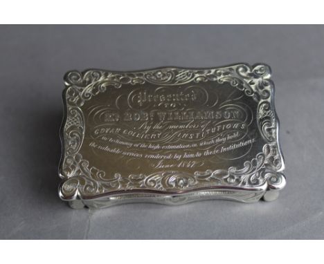 A Victorian silver table snuff box by Edward Smith, the shaped body engraved with leaf scrolls, gilt interior, the lid with p