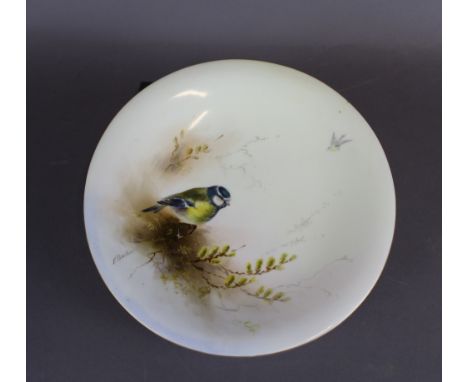 A Royal Worcester porcelain low comport, decorated with a Blue Tit by Ernest Barker, 24cm diameter x 5cm high, signed, purple