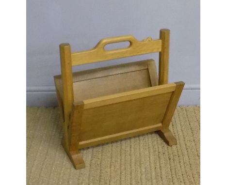 A Robert 'Mouseman' Thompson light oak magazine rack, with carved 'signature' to upper rail, 43cm x 21cm x 46.5cm high Good o