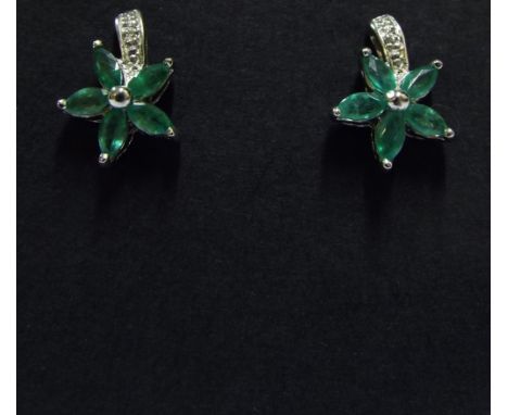 A pair of silver, diamond and emerald earrings

We will post this item worldwide at cost. No packing charge. 