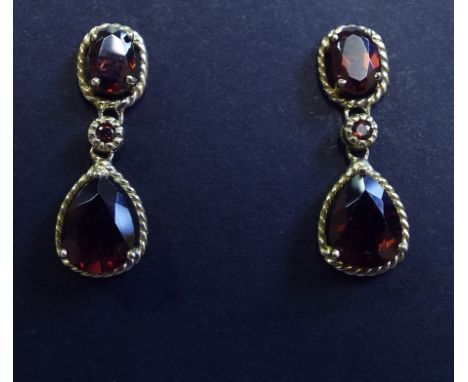 A pair of 9ct gold and garnet double drop earrings

We will post this item worldwide at cost. No packing charge. 