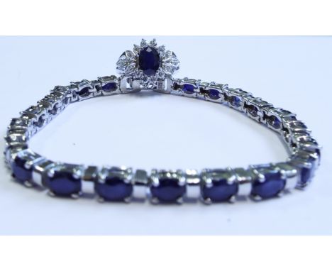 A silver and sapphire line bracelet, and a matching ring (2)

We will post this item worldwide at cost. No packing charge. 