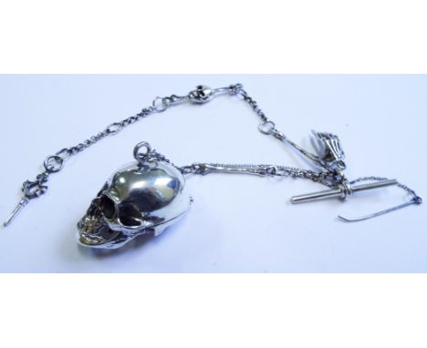 A silver snuff box, in the form of a skull, and a matching chain

We will post this item worldwide at cost. No packing charge