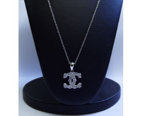 A 9ct gold and diamond necklace, in the form of entwined C's

We will post this item worldwide at cost. No packing charge. 