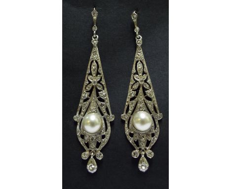 A pair of 9ct gold, silver and pearl drop earrings

We will post this item worldwide at cost. No packing charge.  Condition r