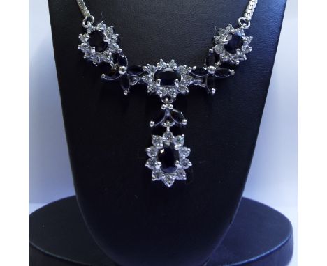 A silver and sapphire necklace

We will post this item worldwide at cost. No packing charge. 