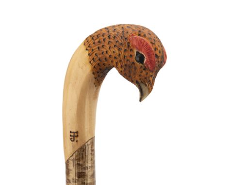 IAN JAMES A HAND CARVED SPORTSMAN'S STAFF, measuring approx. 51in. in length, with ashwood type shaft, the top carved in the 