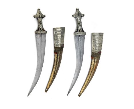 A PAIR OF KHANJAR DAGGERS OF LARGE SIZE, early to mid 20th century, almost certainly Saudi-Arabian, with 15in. curving blades