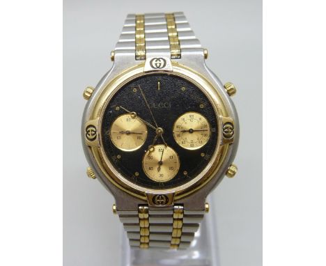 A bi-metal Gucci Chronograph wristwatch, black dial with subsidiary dials to three, six and nine, reference 9400, serial 9086
