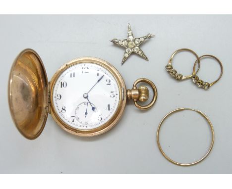 A single 9ct gold hoop earring, two gilt metal and paste rings, a Victorian star burst brooch and a full hunter pocket watch 