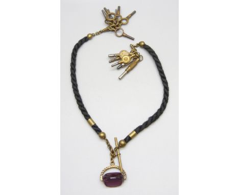 A Victorian mourning Albert chain with watch keys and a fob 