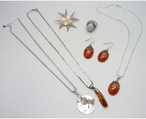 Silver and amber jewellery, a white metal mounted amber pendant, a filigree Maltese Cross brooch, a silver pendant and chain 