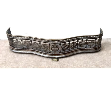 A Regency serpentine fire fender with pierced frieze, 18 x 95 x 33 cm.