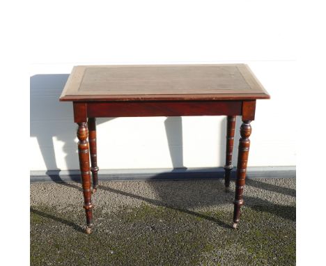 Late Victorian leather topped writing table. On four turned supports terminating on brass and ceramic castors. Height: 74cm W