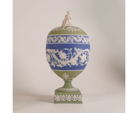 Wedgwood, early tri-colour lidded Arabesque vase. The body, of dip blue Jasperware with intricate scrolling floral reliefs at